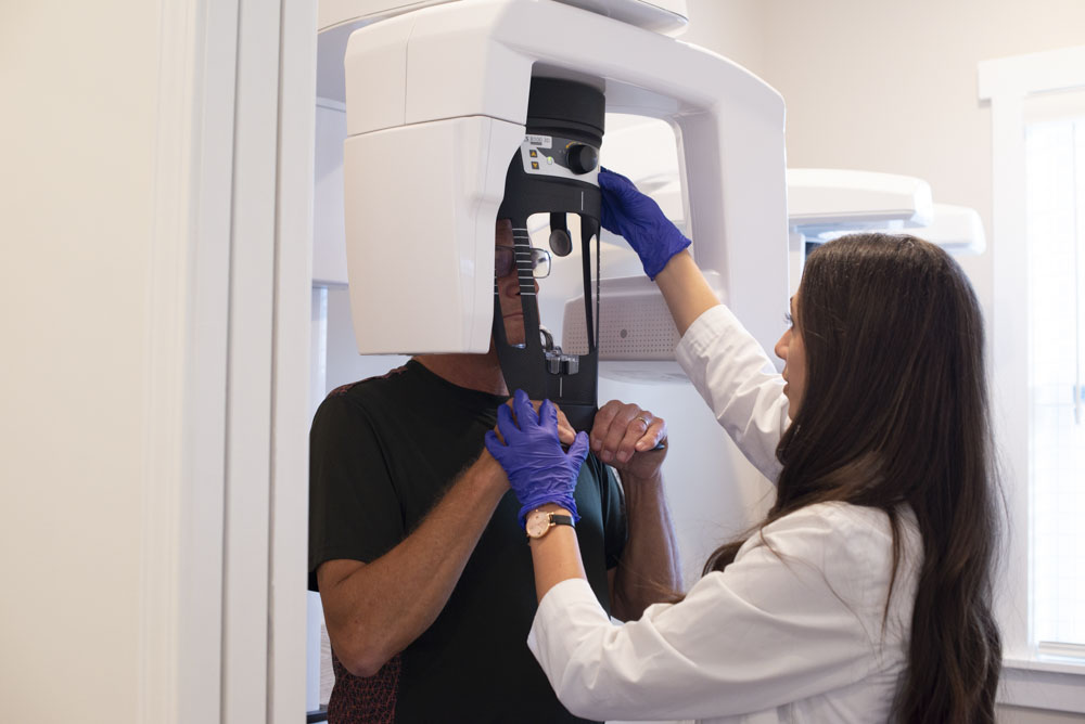 Dr. Monica Bonnin assists a dental patient getting x-rays
