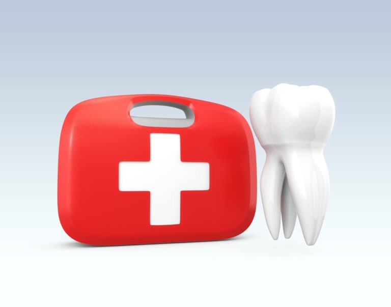 red first-aid kit next to a white tooth