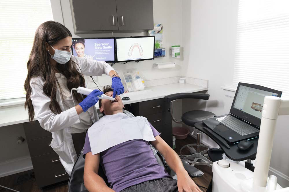 Dr. Monica Bonnin performs a dental cleaning on a patient